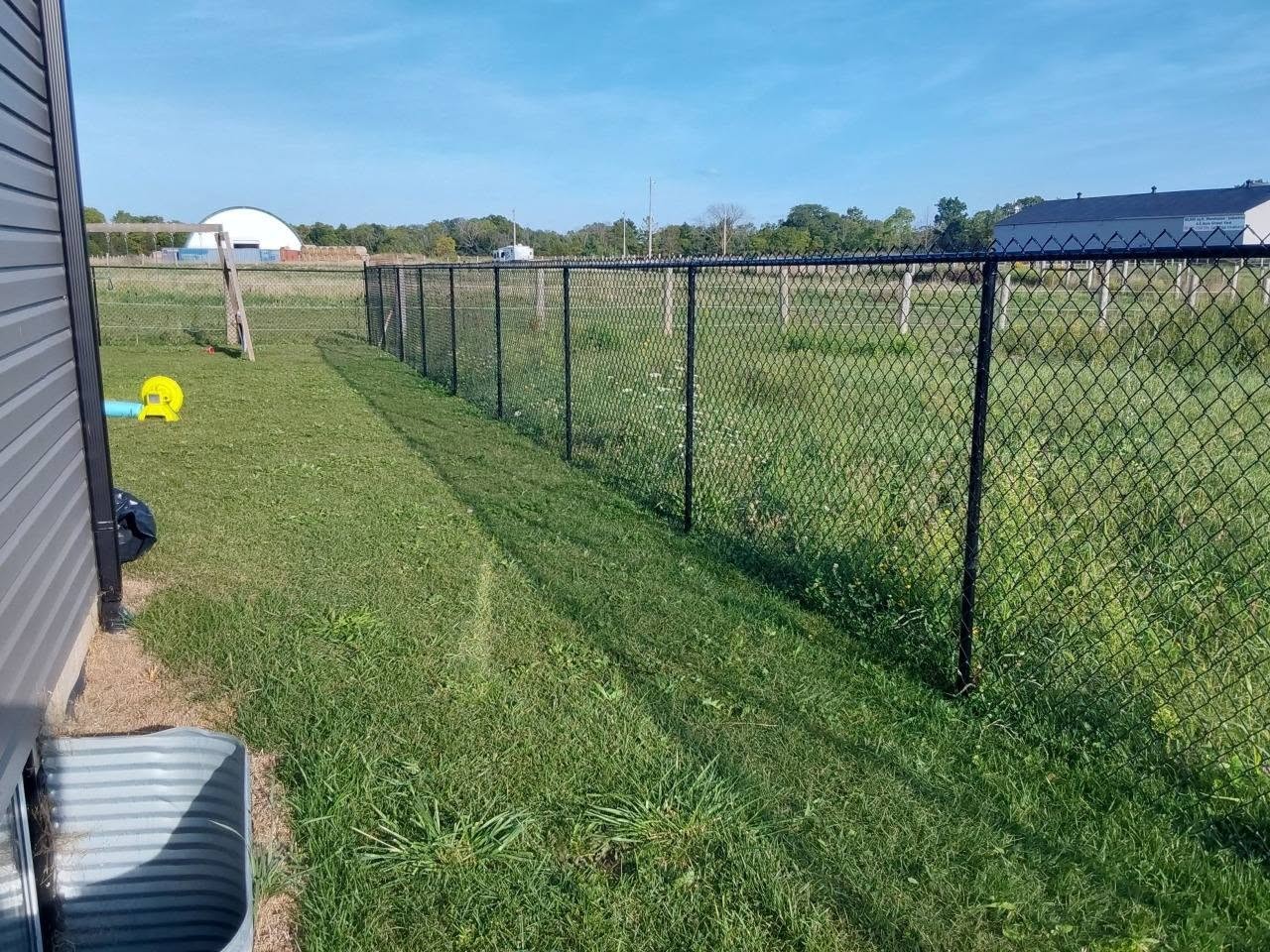 Chain-link boundary fence by B&M Mourad Group Inc.