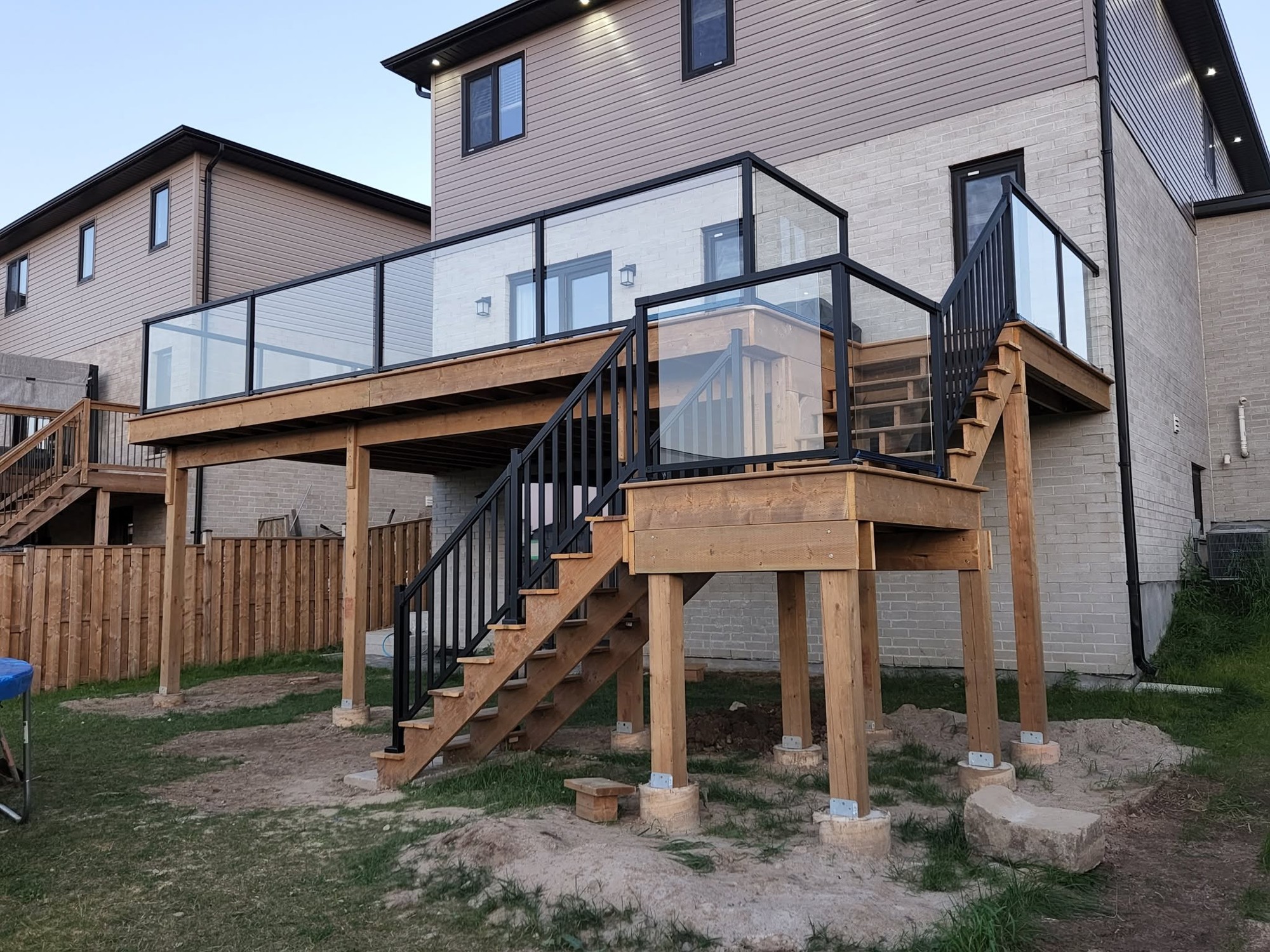 Raised deck & black railings by B&M Mourad Group Inc.