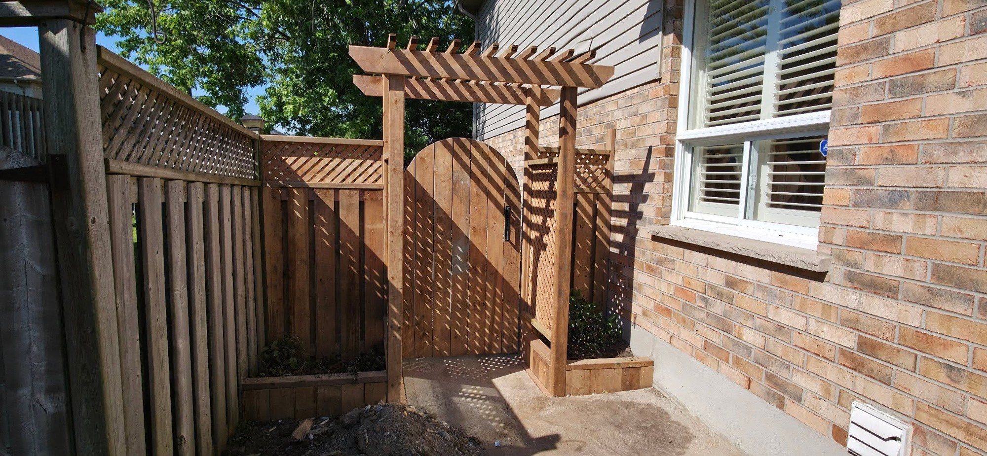 Wood gate & arbor by B&M Mourad Group Inc.